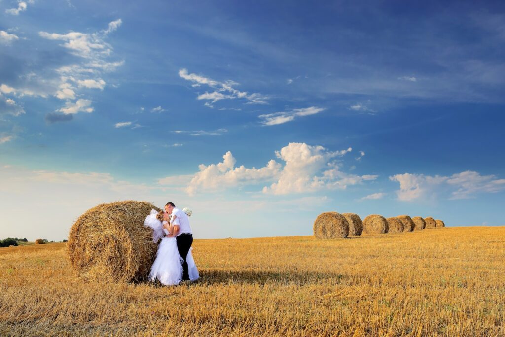 Photo of Couple Kissing Beside Hay Roll-Relationship Is Ready for Marriage