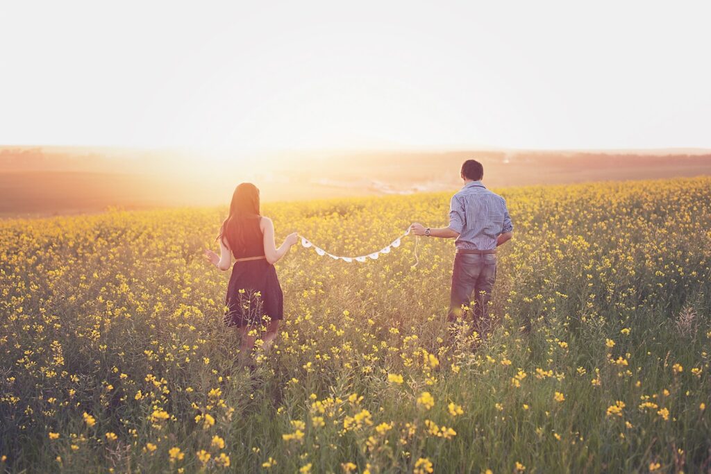 Woman and Man Walking on Yellow Petaled Flower Field-Reconnect with Your Partner
