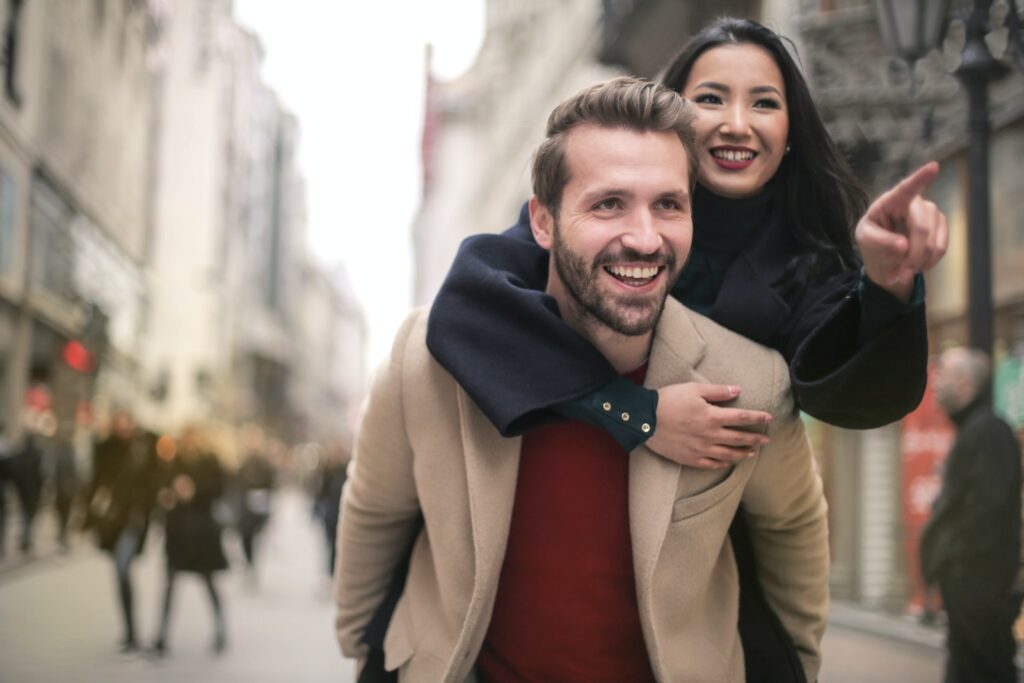 Man in Brown Coat Smiling Beside Woman in Black Coat-Thriving Relationship