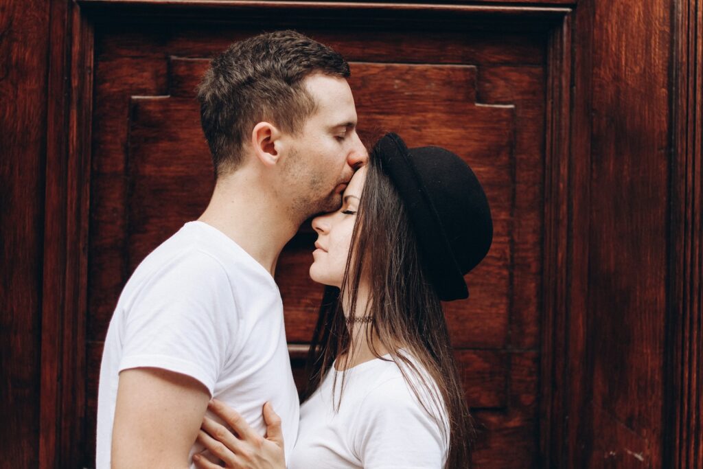 man kissing woman forehead - make your ex-boyfriend miss you