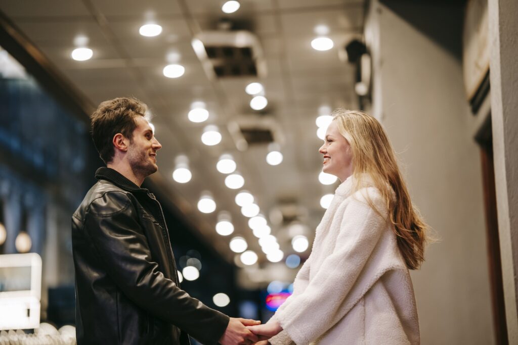 Smiling couple standing in hall of subway-Love Languages