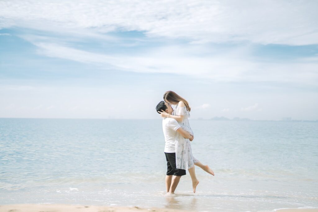 Anonymous couple embracing near ocean on sandy shore-Communication Skills