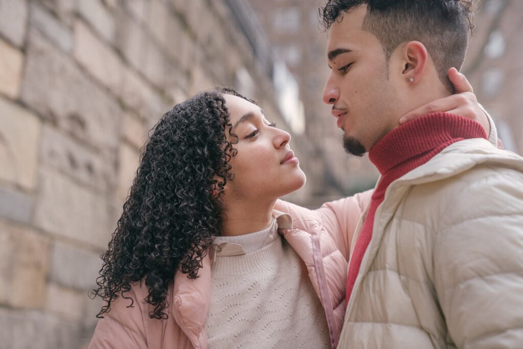 Loving Hispanic couple hugging on street-Interracial Relationship