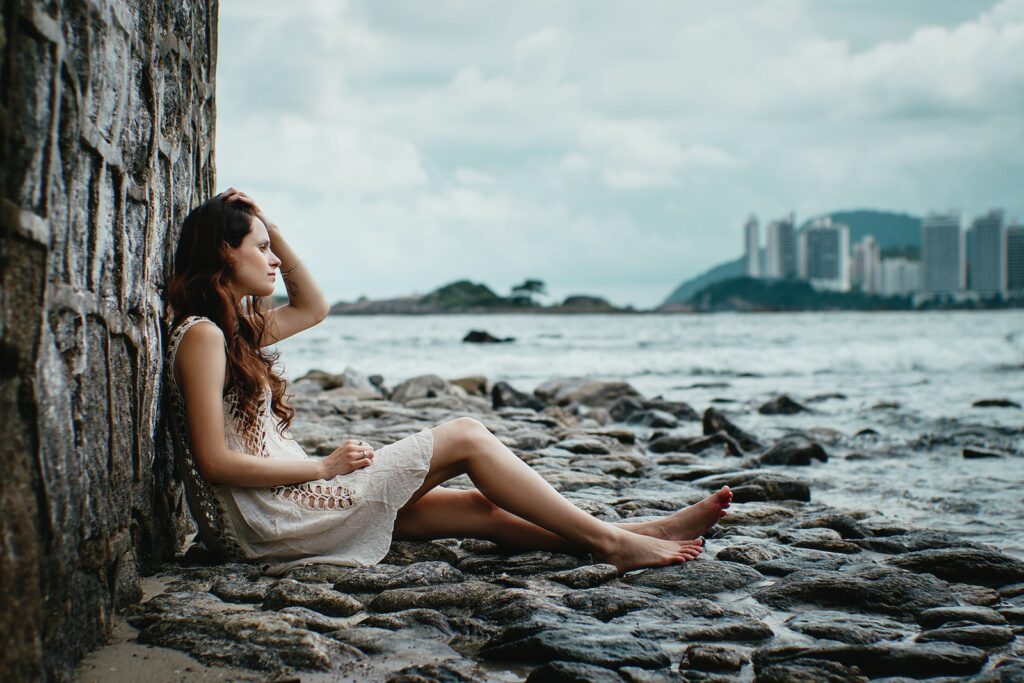 woman leaning on stone wall near body of water Seeing your ex-boyfriend with someone else