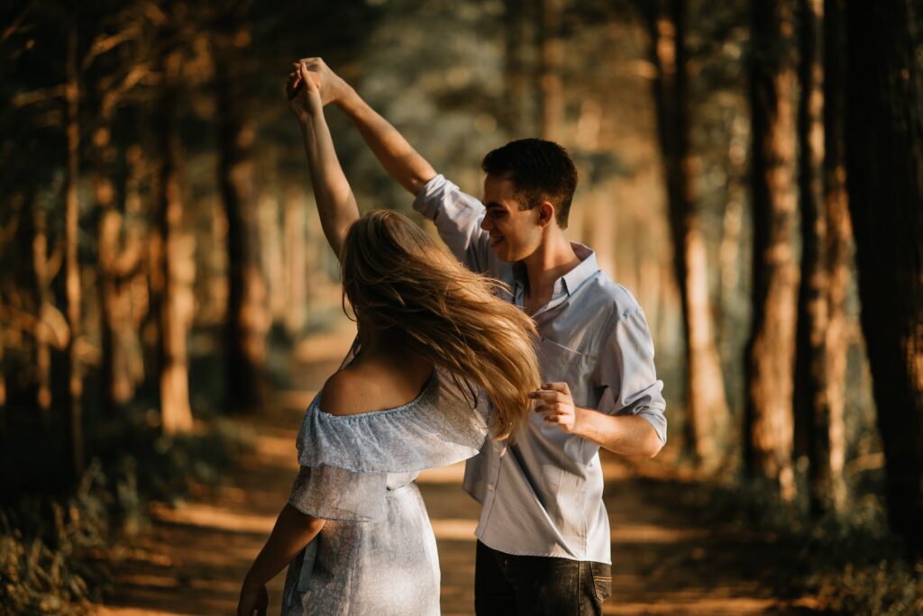 man and woman dancing at center of -trees-your marriage is worth saving-you're in love
