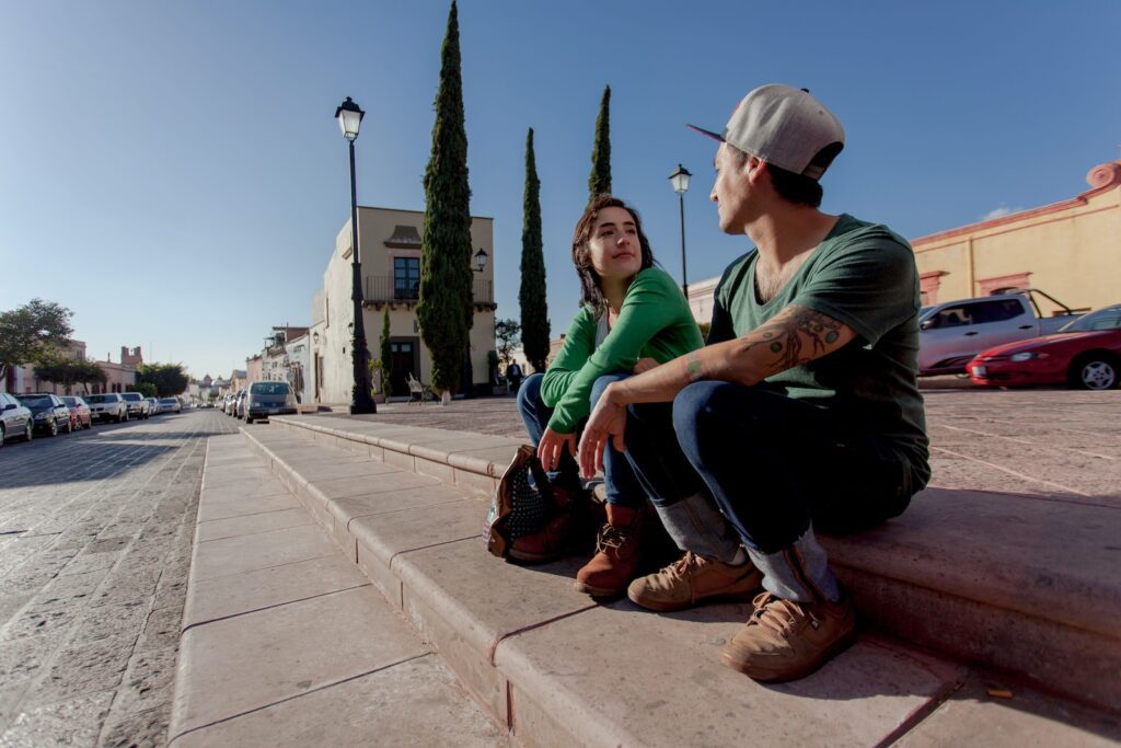 man in green shirt and black pants sitting on concrete bench during daytime-Date Ideas for Couples