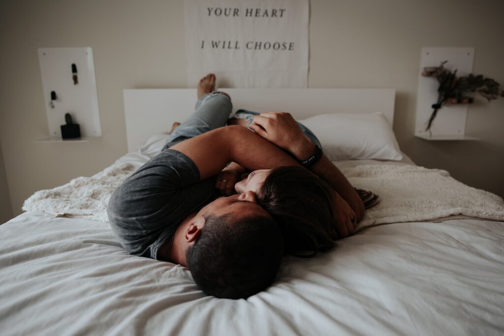 A man and woman cuddling together in bed. fear of love
