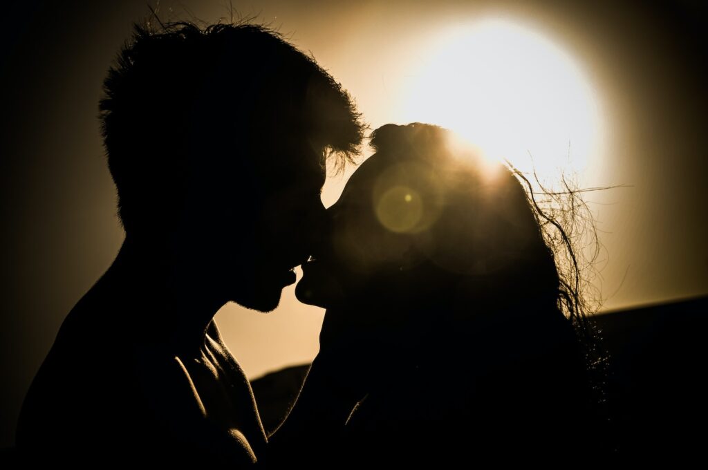 man and woman kissing under the sun-kiss a boy for the first time