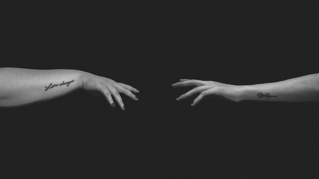 grayscale photo of persons hand- Deal with a Relationship Crisis