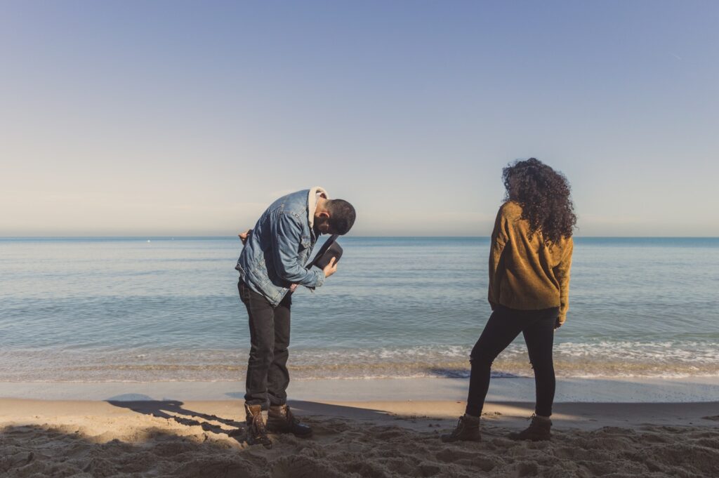 man bowing in front of a woman on seashore during day-a Healthy and Loving Relationship