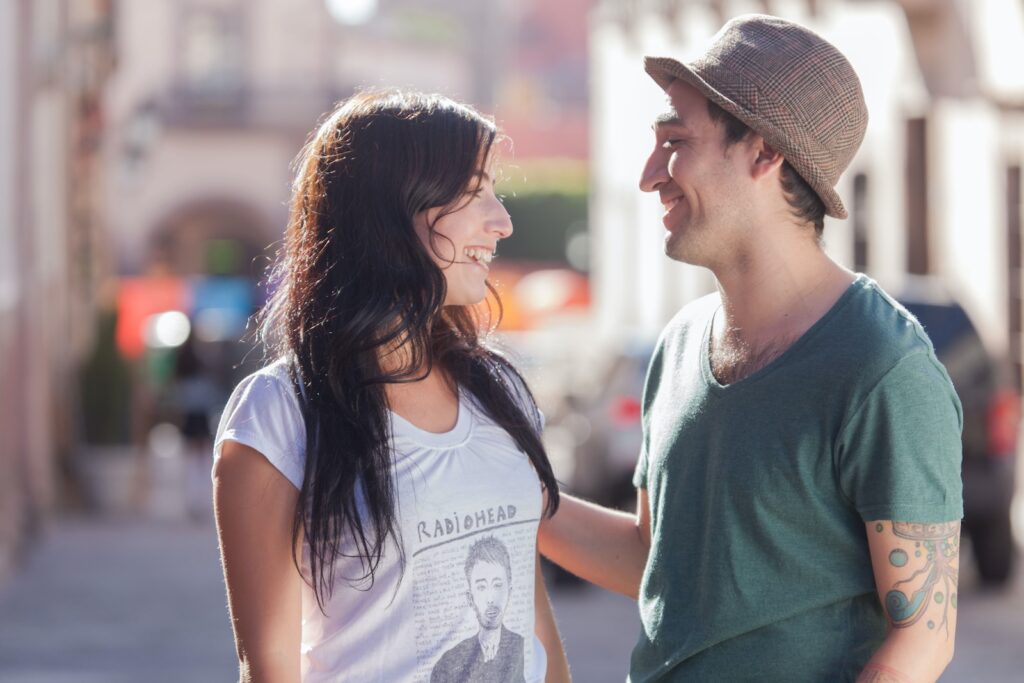 man in green crew neck t-shirt kissing woman in white t-shirt during daytime-Date Ideas for Couples