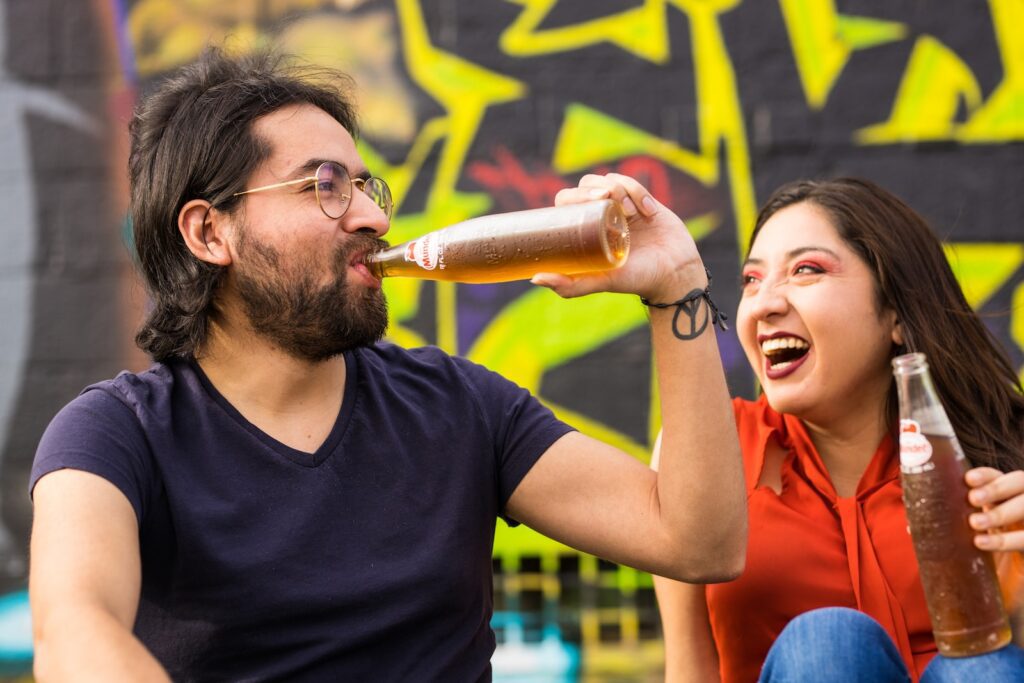 man in black crew neck t-shirt holding woman in red sleeveless dress drinking beer-Strong and Thriving Intimate Relationship