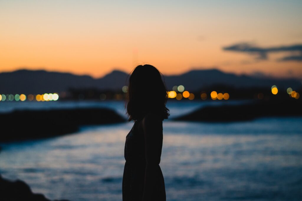 silhouette of woman standing beside body of water-Stop Liking Your Crush