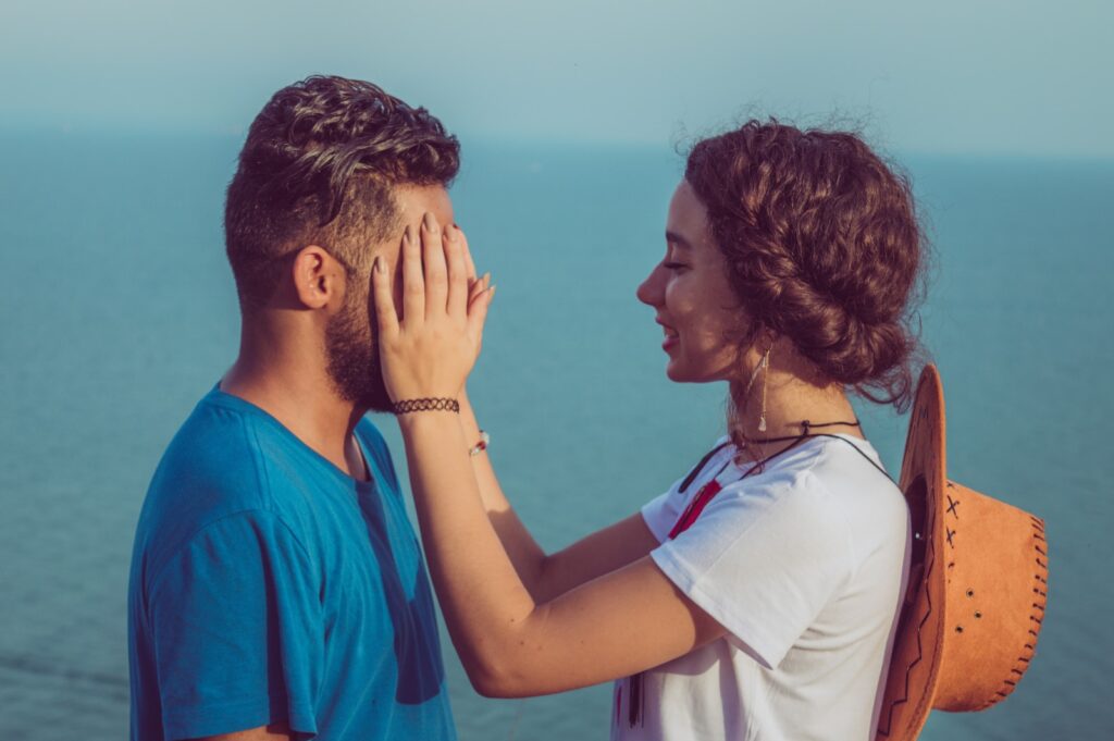 woman covering man's face- deal with conflicts in a relationship