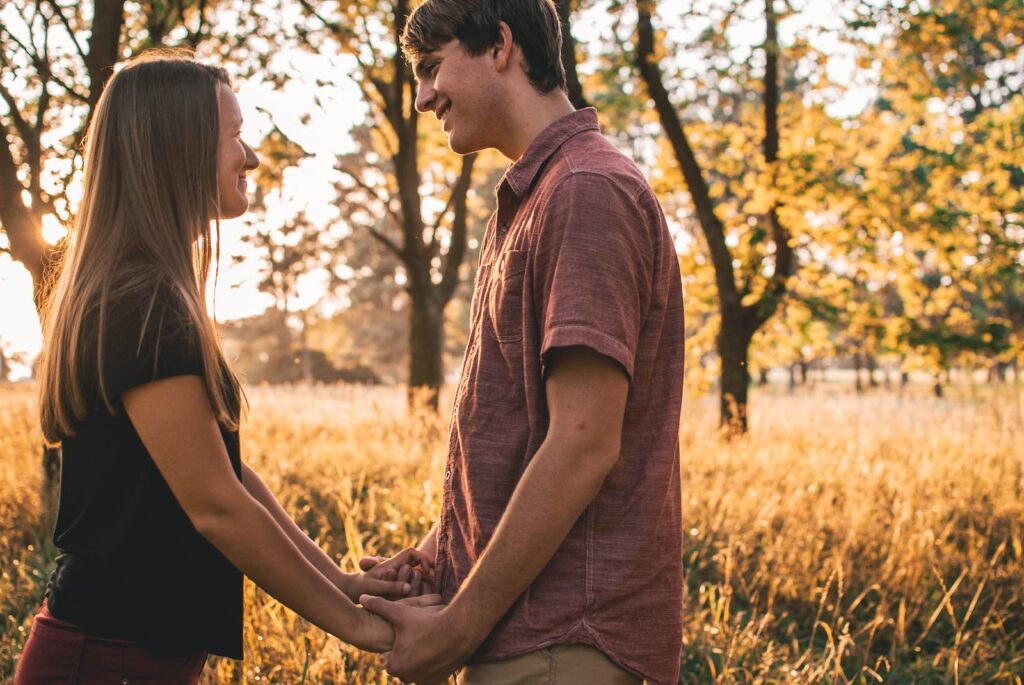 man and woman holding hands while looking at each other - Get Your Ex-Boyfriend Back