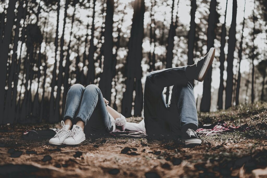 two person lying surrounded by trees- your ex still has feelings for you