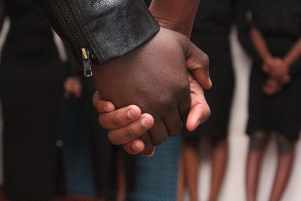 Selective Focus Photography of Man and Woman Holding Hand Each Other Cultivating Trust