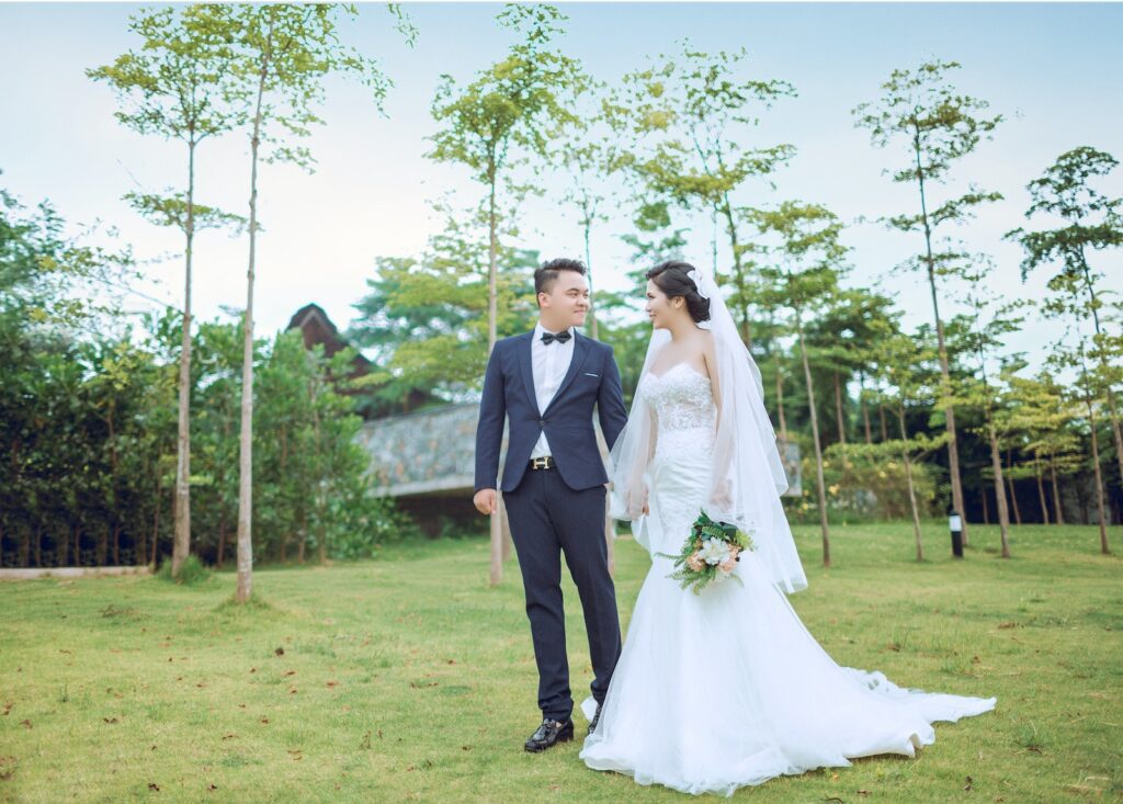 Bride and Groom Standing on Green Grass Surrounded by Green Leafed Trees Surprise Your Partner