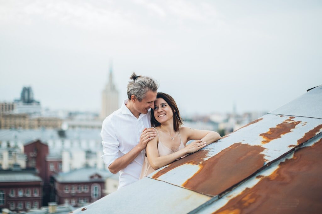 Smiling couple hugging on city roof Seduction Bible