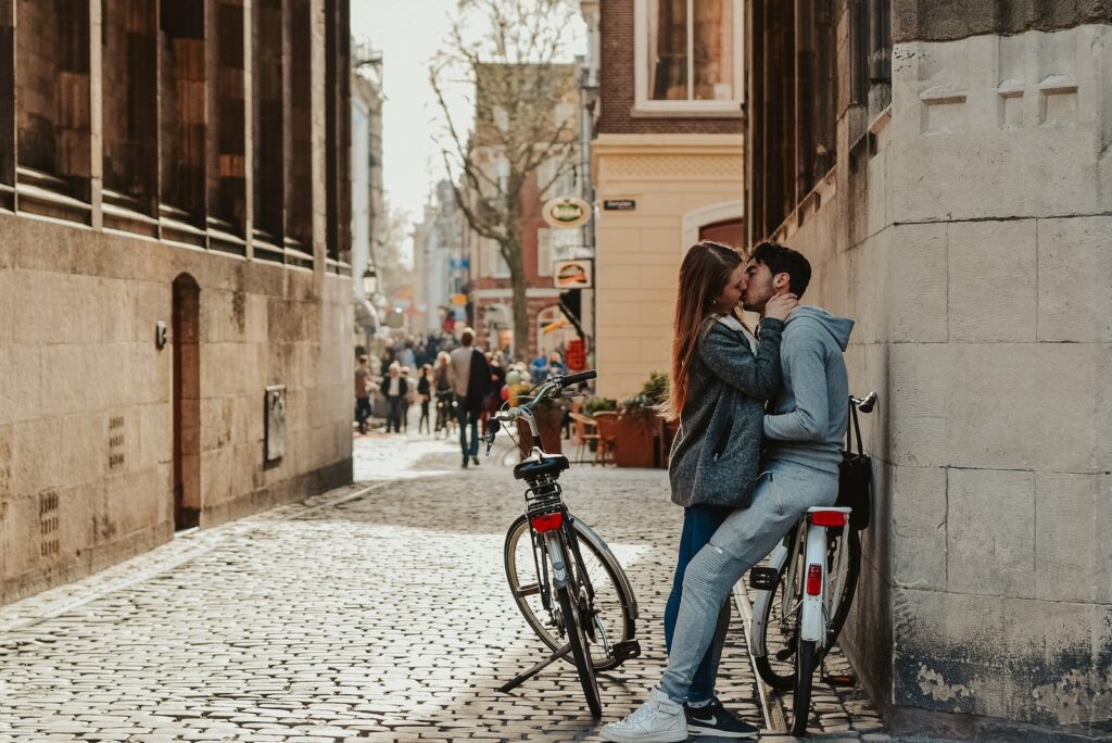 Romantic couple with bicycles kissing on old street Irresistible Allure