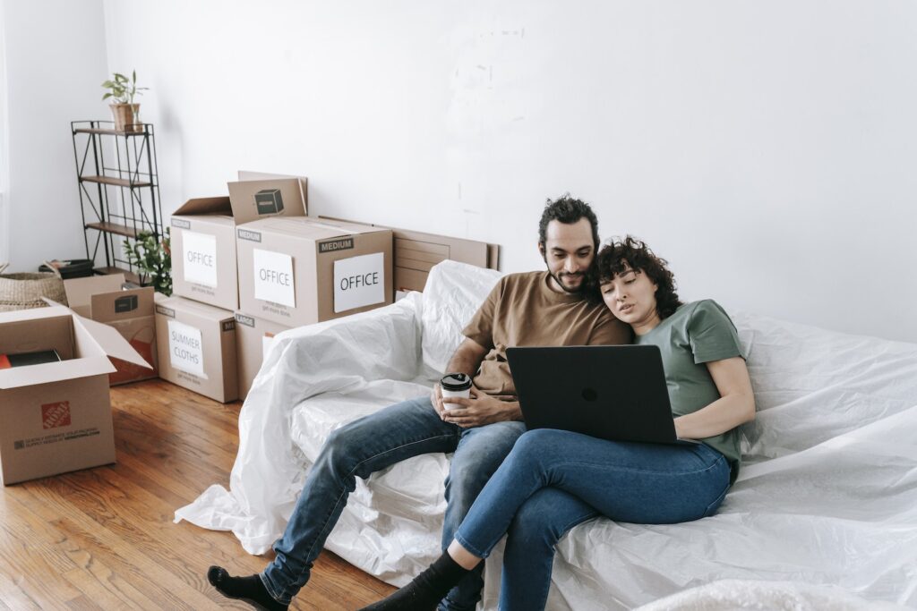 Couple Sitting On A Couch Browsing On Computer Unlock His Heart