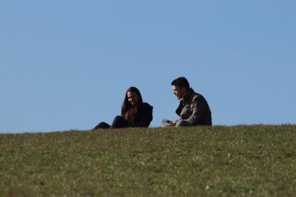 man and woman sitting on green grass field during daytime-Fun and Affordable Date Ideas