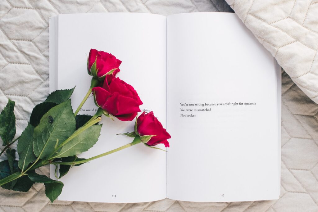 three red rose flowers on white open book-Rebuilding Trust After Infidelity