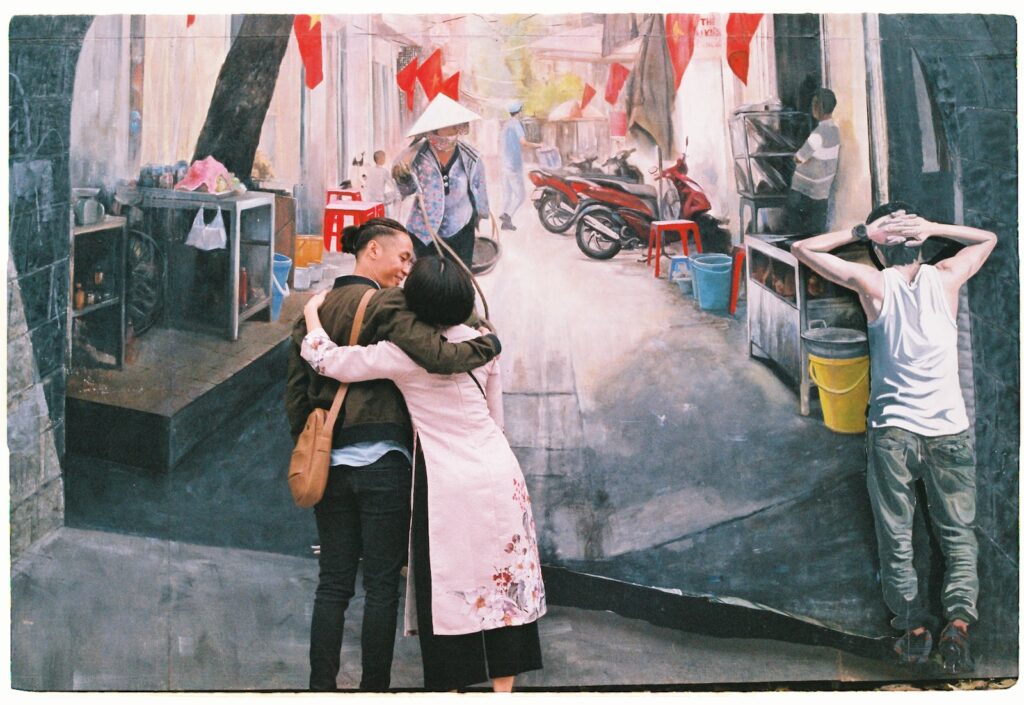 photo of man and woman hugging each other front of wall art-Express Your Love to Your Partner