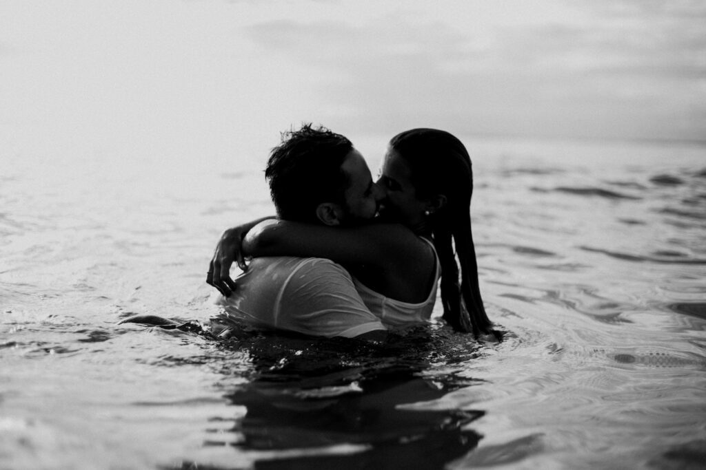Man and Woman Kissing Together on Body of Water-Confidence in Dating