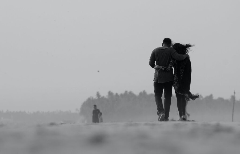 Grayscale Photography of Couple Walking on Ground-a Married Man Loves You