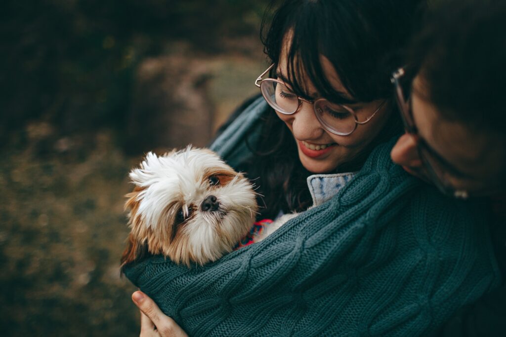 Selective Focus Photography of White and Tan Shih Tzu Puppy Carrying by Smiling Woman-Your Date