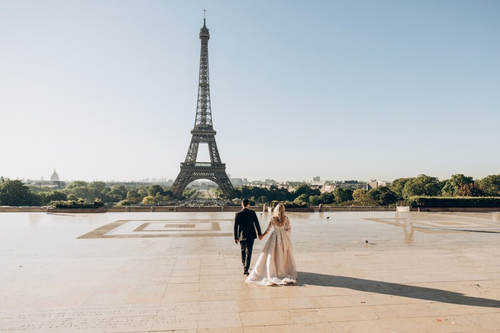 Woman and Man Walking in Park in Front of Eiffel Tower-Your Partner Admires You