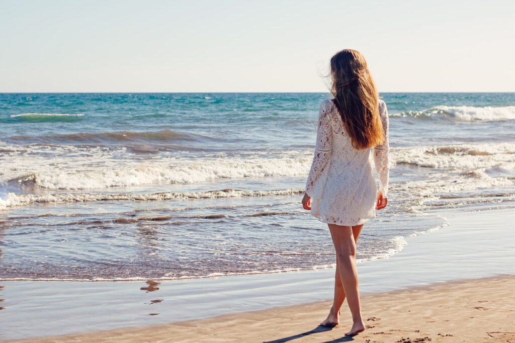 young woman, beach, dress-Things Women Do to Attract Men