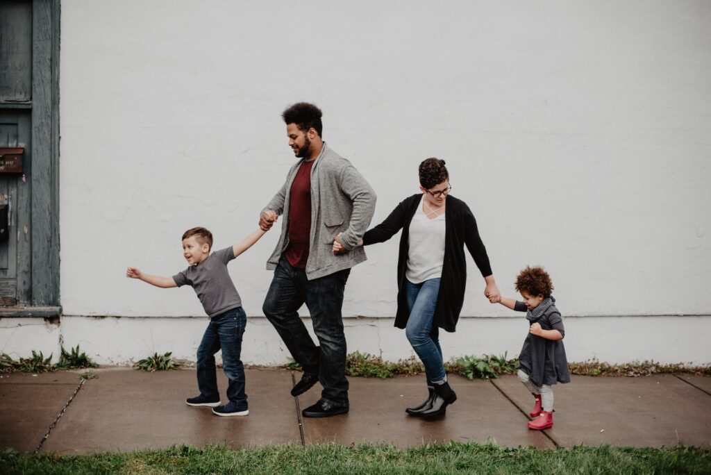 Family Of Four Walking At The Street-Men Wish