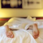 Person Lying on Bed Covering White Blanket-Red Flags