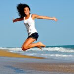 woman, beach, jump-Get Over a Breakup Fast
