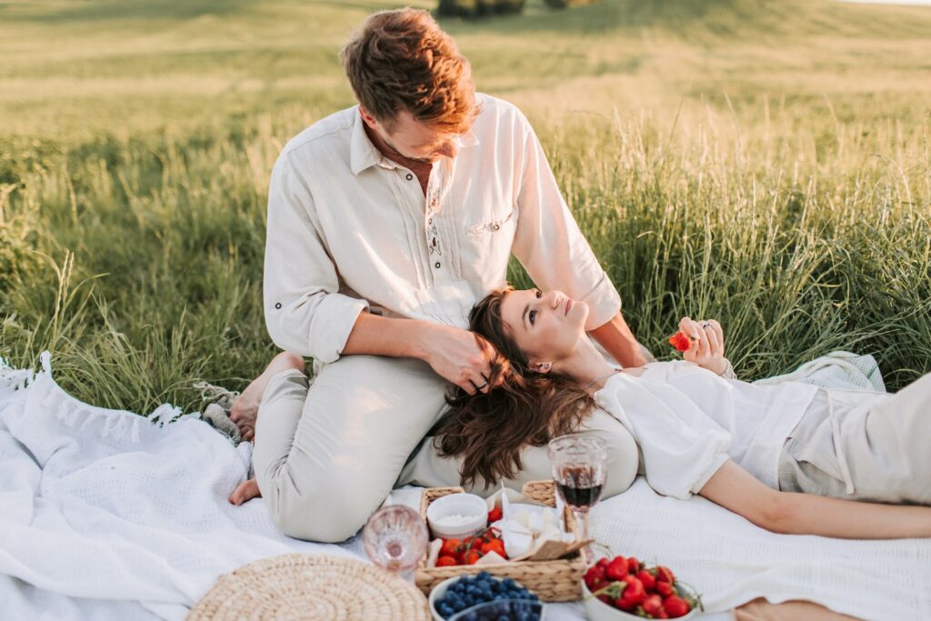 A Woman Lying on Her Partners Lap while Sitting on Picnic Blanket-Quotes About Love