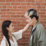 Loving ethnic couple standing near brick wall and looking at each other-Bible Say About Supporting Your Spouse