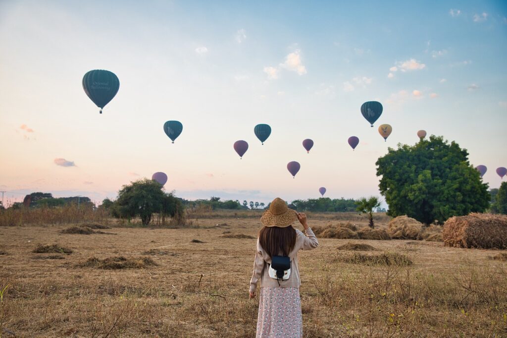 woman, field, hot air balloons-Emotional Attraction