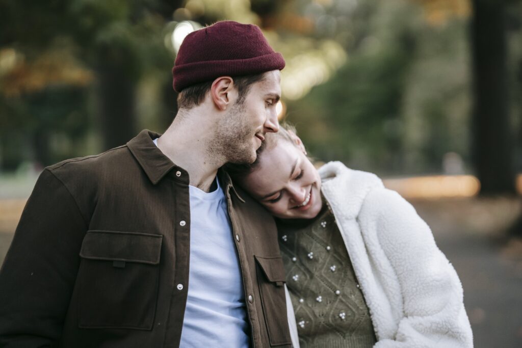 Romantic young couple in stylish warm clothes smiling and embracing during date on sunny autumn day-Bible Say About Supporting Your Spouse