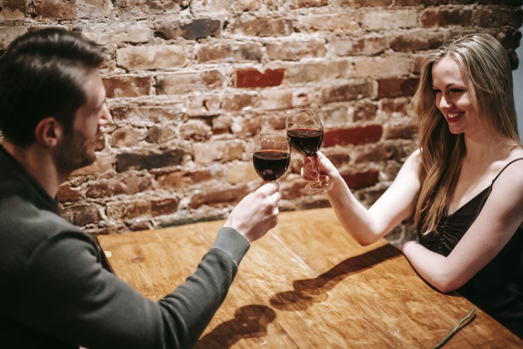 Couple having romantic dinner in cafeteria cheering with wineglasses-Transformation