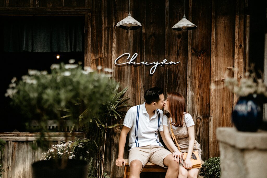 Kissing Asian couple sitting on bench-Good Morning Messages for Him That Touch the Heart