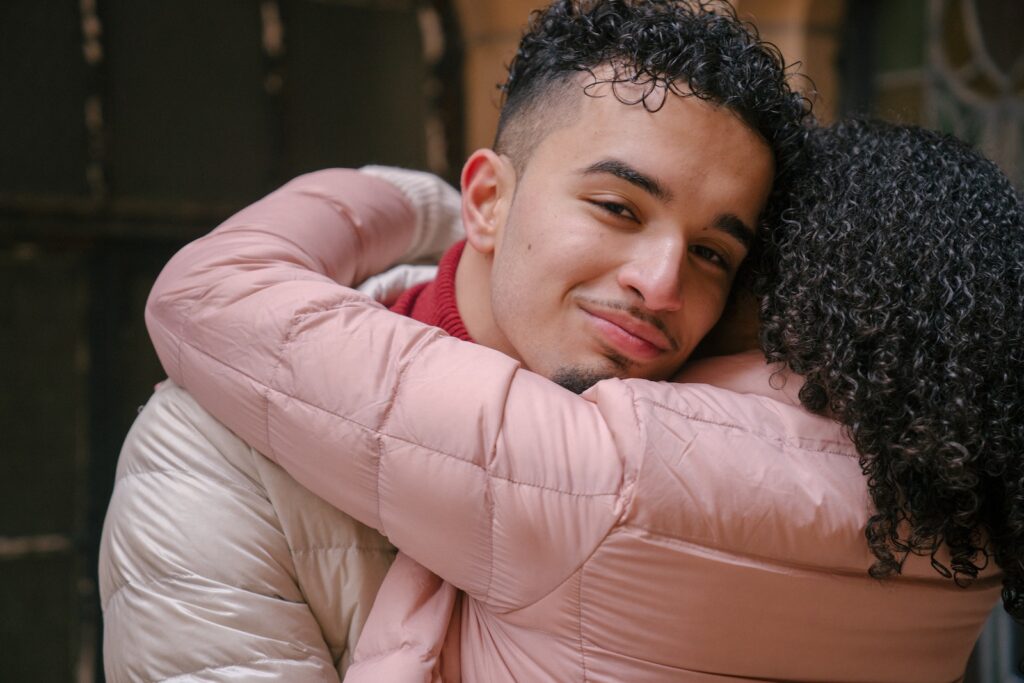 Smiling ethnic boyfriend with curly hair hugging girlfriend-Women Should Look for in a Partner