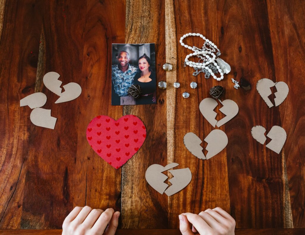 A Photo of a Couple and Paper Cutouts of Broken Hearts-Lasting and Loving Relationship